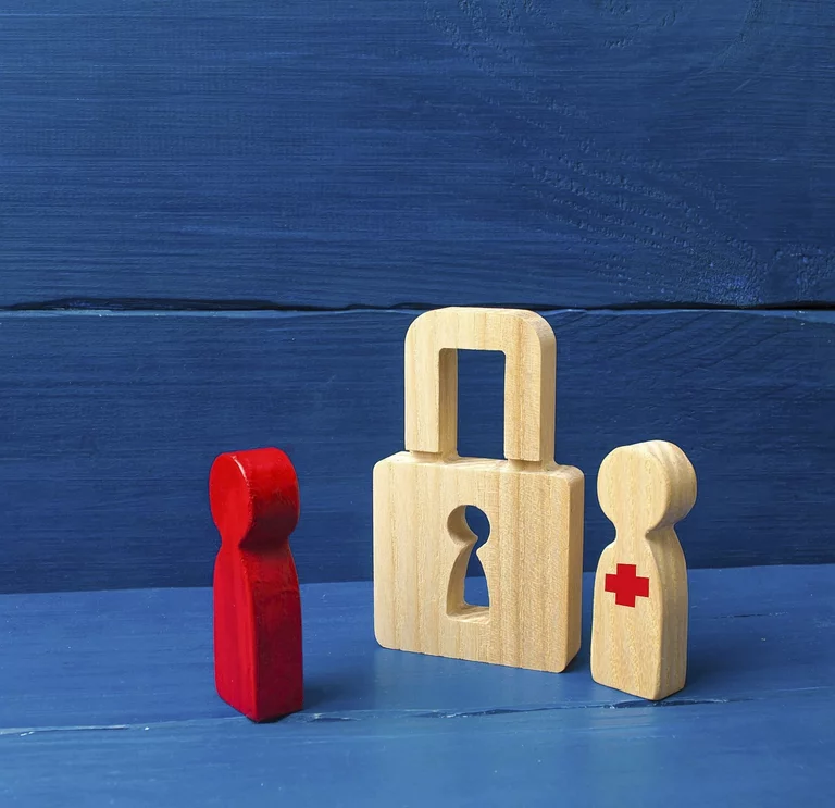 The person stands near the padlock and protects him from the red person. concept of the preservation of secrets, information and values. Protection of data and personal information. Hacking attack